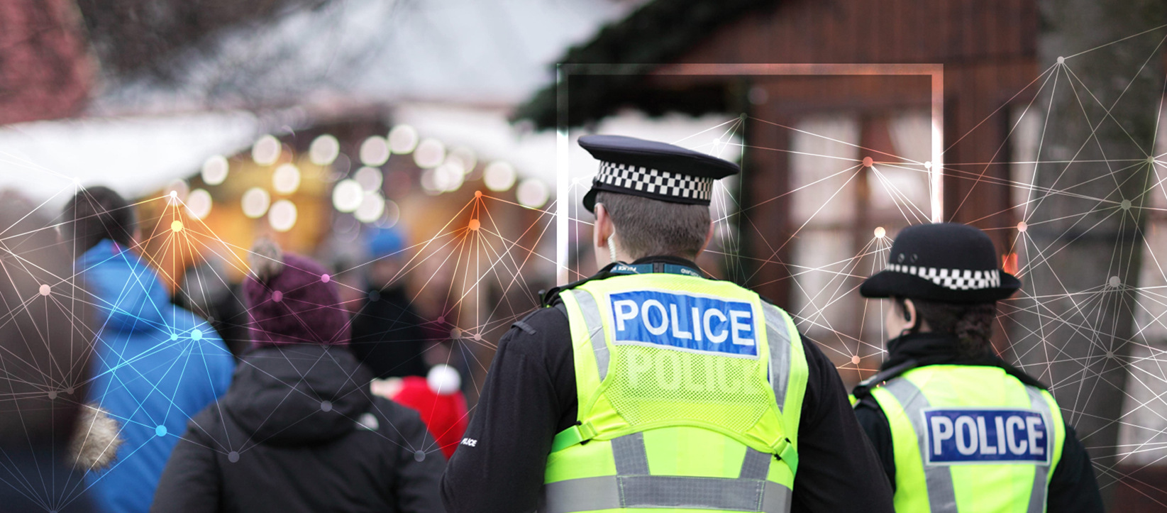 photo of male and female police officers patrolling an urban street